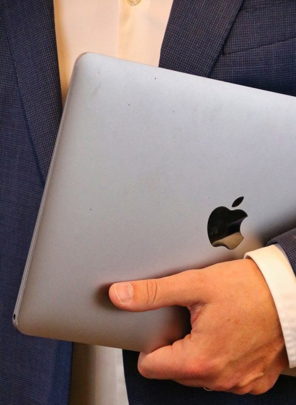 man holding a macbook